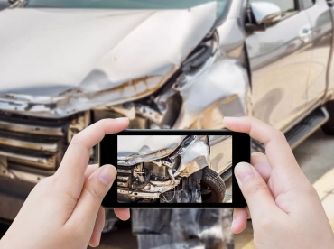 Drive taking photo of post accident damage