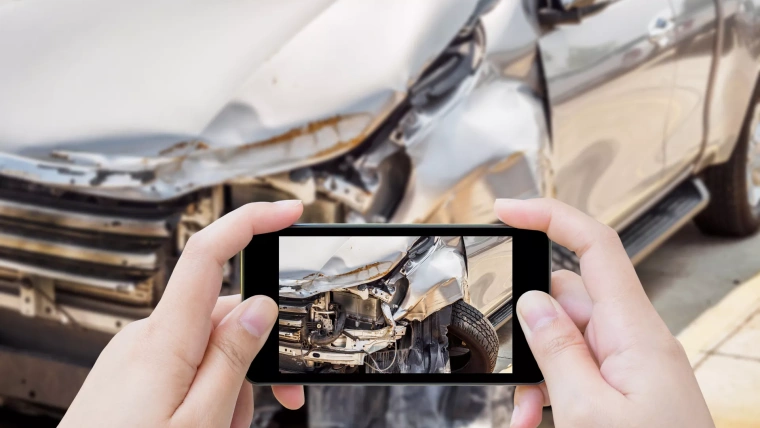 Drive taking photo of post accident damage