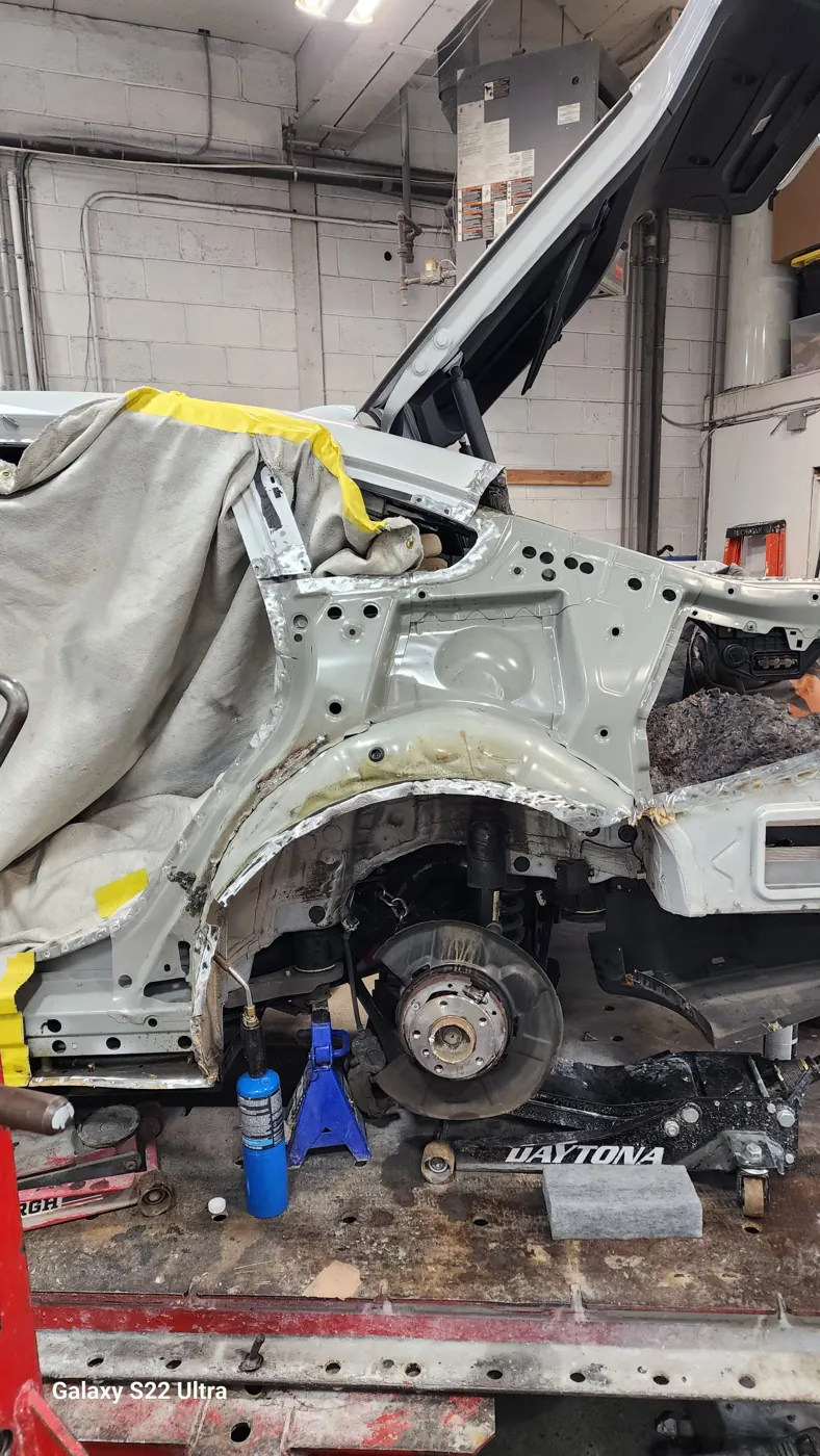 Unibody structural repair in progress with panels removed